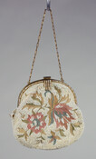 Beaded and floral embroidered bag with coral and green embroidered motifs worked in chain stitch. White beads applied to form solid background. Gold metal hinged frame decorated with applied shell trim which is repeated on clasp, with attached 11 inch gold chain handle. Purse is lined with tan silk, featuring a pocket to hold matching…