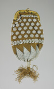 Brown knit bag with white beaded embroidery in a geometric pattern. Gold metal frame opening with small metal ring at top center. Thread fringe at bottom trimmed with white beads.
