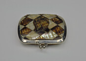 Change purse with inlaid pattern of alternating diamonds of mother of pearl and tortoiseshell. A central inlaid tortoiseshell shield motif is inscribed, "Bremen." Opens and closes with silver clasp.