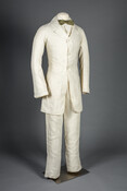 White linen, three-piece summer suit that consists of a jacket, waistcoat, and pants.
