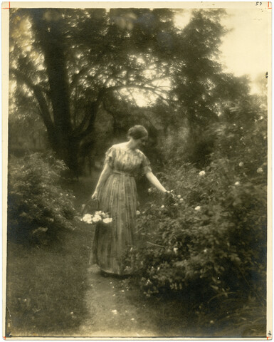 Lizette Woodworth Reese in flower garden — circa 1915