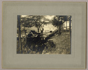 Three men on a felled tree in Tolchester, Maryland, following a storm and flood. Damaged structures can be seen in the background. Tolchester was the site of the Tolchester Beach Amusement Park, which consisted of a bathing beach, amusement park, racetrack, and hotel, and was in operation from 1877 to 1962. The Kent County park…