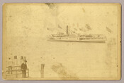 View of "Louise," a sidewheel passenger steamboat, on the Chesapeake Bay. Two figures on a smaller vessel can be seen in the foreground. Owned by the Tolchester Steamboat Company, the "Louise" was one of the most popular excursion steamers on the Chesapeake Bay and could hold 2,500 passengers. Verso transcription: William H. Hudson
