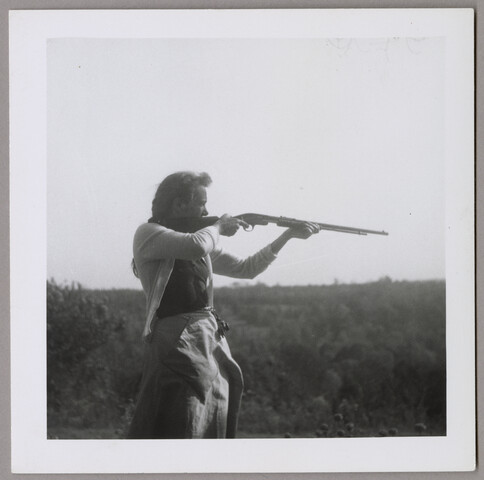 Claire shooting a gun — circa 1930-1950