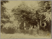 Group portrait of Serena Smith, Laura E. Ford, and Isabel Reeves on the front steps of the Smith house in Georgetown, Maryland. Serena Smith has a comb in her hair and the child is Isabel Reeves. The view of the house is obscured by trees. Also known as the Archibald Wright House, this building was…