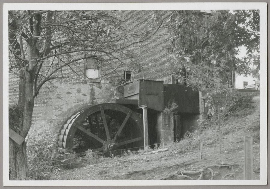 View of the Higman Mill water wheel located in Millington, Maryland. Fed by a branch of the Chester River, the wheel is located on the east side of the building. This flour and grist mill, also known as the Massey Mill and Gilpin's Mill, was in operation from 1763 until 1954 and is the only…