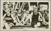 Group portrait of nine swimmers in bathing suits and caps at Betterton Beach in Kent County, Maryland. Located at the end of a peninsula where the Sassafras River enters the Chesapeake Bay, Betterton was a popular beach resort on the Eastern Shore during the late 19th and early 20th centuries.