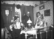 A Bock Beer party scene with five men toasting in the parlor of a home.