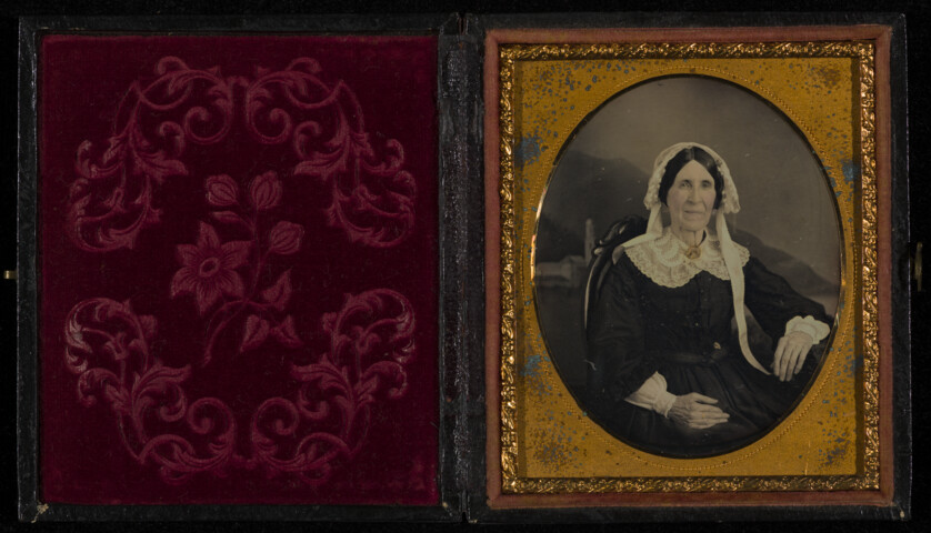 Portrait of woman in white cap, cuffs, and collar — circa 1850