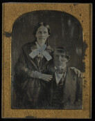 Daguerreotype portrait of an unidentified woman standing beside an unidentified seated man.