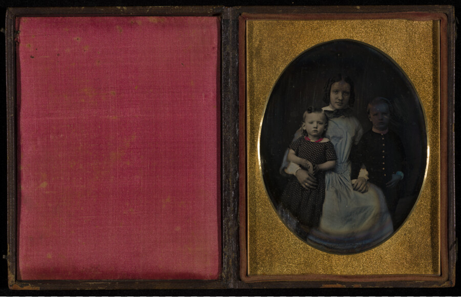 Daguerreotype group portrait of Frances Hollis Webster Hines (1832-1877) with two children. Frances was the daughter of Reverend Augustus Webster (1806-1890) of Baltimore and his wife, Mary Jane Hines (1819-1892). In 1855, she married William Marshall Hines (1821-1886). The couple were parents to: William Marshall (1852-); Augustus Webster (1860-1914); and Frances Hollis (1867-1928). The children…