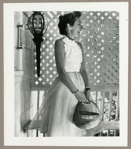 Portrait of Claire McCardell holding a basket — circa 1940