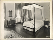 A bedroom in the Homewood estate, including a bed, chest of drawers, mirror, chair, and bedside tables. Homewood was built between 1801 and 1806 as a country home for Charles Carroll, Jr., son of Charles Carroll of Carrollton who was a signer of the Declaration of Independence. The Federal-period Palladian home was in the Carroll…