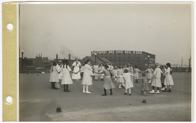 Children playing on a recreation pier deck. — 1914-08-01