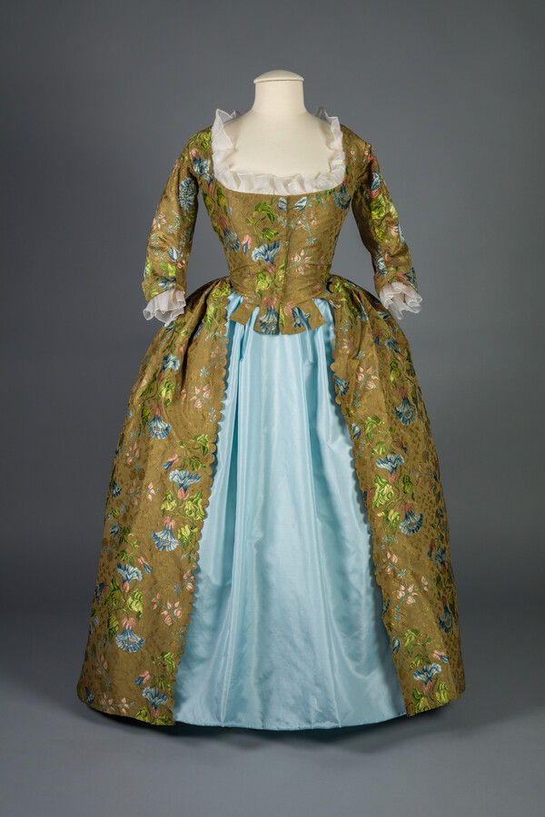 Silk brocade dress, first worn by Elizabeth Woodrop Davey (1726–1782) and later worn by Catherine Davey McKim (1766–1860). Women routinely restyled old-fashioned garments. When originally constructed in the 1740s, this silk brocade dress’s bodice accommodated for the display of a stomacher, a removable decorative panel. Catherine Davey McKim, who owned this dress during its last…