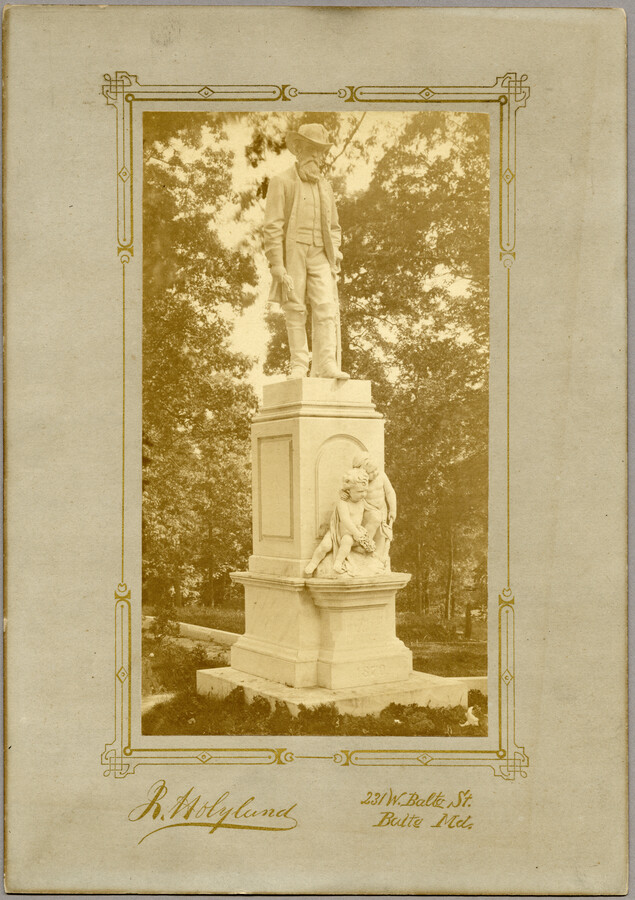 View of a Confederate monument at Loudon Park Cemetery in Baltimore, Maryland. The monument was sculpted by Frederick Volck (1833-1891) and features a Confederate soldier standing above a pair of young children, or possibly cherubs. A subsection of this cemetery has been federally owned since 1961 and is known as Loudon Park National Cemetery. This…