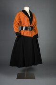 Pumpkin and black rayon faille trapeze-style Monastic dress, cinched by a coordinating leather and fabric sash, made by Claire McCardell Clothes by Townley