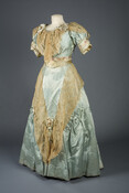 Two-piece lady's afternoon dress of light blue silk damask with japonesque chrysanthemum pattern. Embellished with lace and floral silk ribbon. Worn by First Lady Frances Folsom Cleveland (1864-1947) in her portrait photographs by Frances Benjamin in 1887. Originally made in the 1880s, this dress was altered by either Barton or the First Lady in the…