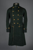 Hunter green wool livery overcoat with black cuffs, cream piping, and brass buttons that feature a stag motif, the Ridgely family crest.