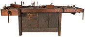 Wooden workbench of Enrico A. Liberti with cabinetmaker's wood-carving tools and planes, furniture patterns and cut-outs as well as some furniture parts.