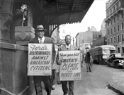 Paul Robeson (left) and Dr. John E.T. Camper (right) holding NAACP Baltimore branch protest signs as they march against the Jim Crow admission policies at Ford's Theatre. By 1952, the theater (once located at 320 West Fayette Street, Baltimore, Maryland) dropped its segregation policies, but struggled to remain open and was eventually demolished in 1964…