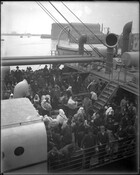 Immigrants on board the North German Lloyd steamship the SS Neckar. The passengers stand with their belongings, preparing to disembark at the immigration station at Pier 9 in the Locust Point area of Baltimore, Maryland.