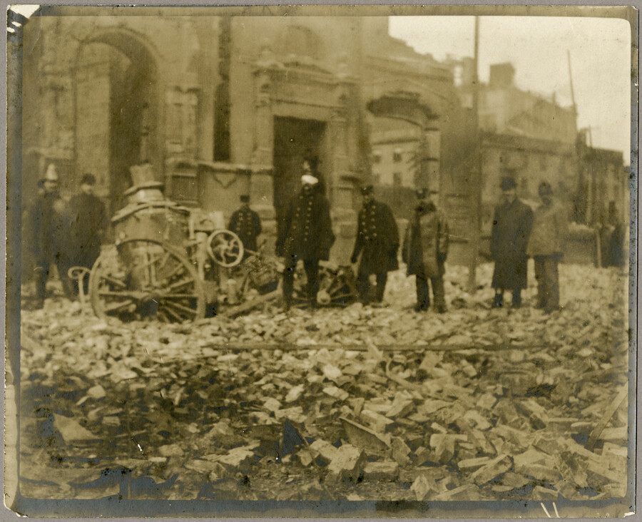 Firefighters pose with their LaFrance "Metropolitan" steam fire pumper at German Street and Sharp Street amidst debris from the Great Baltimore Fire. The Exchange Bank is visible in the background.