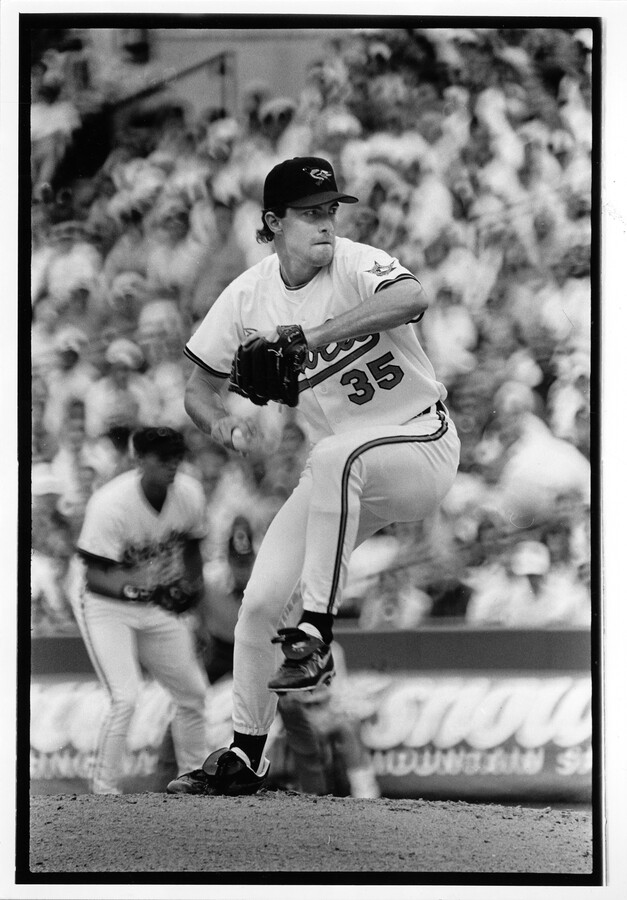 Photograph of Baltimore Orioles pitcher Mike Mussina pitching a ball during a home game in Baltimore, Maryland.