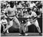 Photograph of Baltimore Orioles first baseman David Segui catching a ball beside New York Yankee Bernie Williams during a game in Baltimore, Maryland.