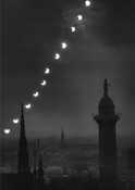 A photograph capturing the path of an eclipse over the Washington Monument in Baltimore, Maryland.
