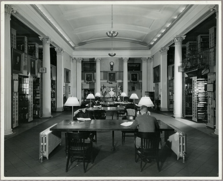View of the Maryland Historical Society library, with multiple patrons seated at large wooden tables.