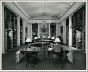 View of the Maryland Historical Society library, with multiple patrons seated at large wooden tables.