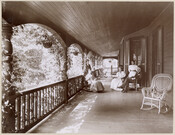 A group on the porch of La Paix, the summer home of the Lawrence Turnbull family, located on York Road near Sheppard Station in Towson, Maryland. Seated at left is Francese Hubbard Litchfield Turnbull (1844-1927) and sitting opposite of her is Lawrence Turnbull (1843-1919), her husband. Their son, Bayard Turnbull (1879-1954), stands behind Francese Turnbull.…