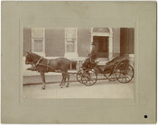 A victoria carriage with coachman and a pair of horses waiting outside of the Thomas family residence at 1010 St. Paul Street in Baltimore, Maryland. Douglas Hamilton Thomas built the home in the early 1890s and maintained it during his lifetime. The home was eventually demolished and the St. Paul Regency apartment building was built…