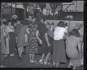 A line of women participate in one of the attractions at Carlin's Park, an amusement park that once existed at 3300 Reisterstown Road near Druid Hill Park in Baltimore, Maryland.