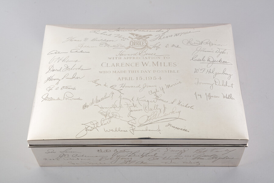 Sterling silver humidor presented to Clarence W. Miles (1897-1977) following the move of the former St. Louis Browns to Baltimore. Miles was the first president and chairman of the board of the Baltimore Orioles after his efforts brought a baseball team to the city in 1954. The humidor, engraved with the names of different members…