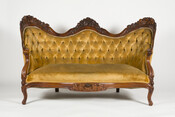 Rococo Revival settee or sofa upholstered in gold velvet, ca. 1855, by John Henry Belter (1804-1863) of New York. It was part of a parlor suite known as "Rosalie & Grapes" that included an armchair and two side chairs. It was specifically made for the "Wilson" family who occupied 505 Park Avenue, Baltimore, Maryland. It…