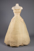 On January 8, 1959, Mary Lawrence Pitcher performed as a New Orleans Maid at the New Orleans Day Ball. For her performance, the fashionable Baltimorean wore this ivory tulle gown by Mollie Stone of New York, who drew direct inspiration from Irish designer Sybil Connolly’s evening dress published in a 1954 Vogue. Stone’s interpretation showcases…