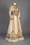 Helen Rolfe Hopkins Thom (1869-1948), who was listed in the 1915 publication of "Woman’s Who’s Who of America," wore this sheer white muslin dress, which features a design of black braided trim entwined in floral motifs. After attending the first class of the Woman’s College of Baltimore City, now Goucher College, and graduating from Bryn…