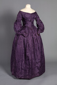 Purple silk damask dress worn by Elizabeth Evans Hoogewerff (1803-1888). Distinguishing features of this dress's construction include its fan-pleated bodice, sleeves, and draw-loom silk damask that dates to the 1740s.