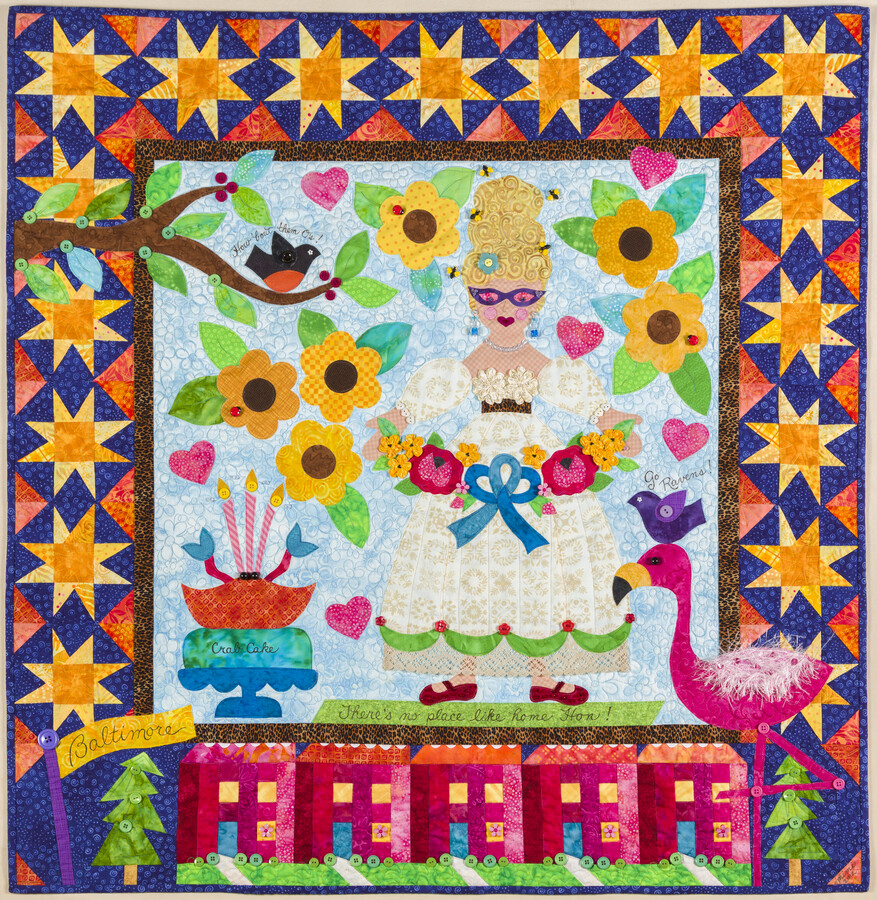 Baltimore Hon quilt depicting a woman with a beehive hairdo, flamingo, raven, crab cake, oriole, row homes, and black-eyed Susans. From creator Mimi Dietrich: “I wanted to make a Baltimore quilt with a lighter style. In 2010, I took a class with Mary Lou Weidman who is famous for her funky story quilts. Look closely…