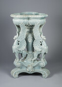 A robin's egg blue majolica glazed fern stand with griffin support. This piece was designed by Herbert W. Beattie (1863-1918) and produced by the Edwin Bennett Pottery Company. In 1904, it was exhibited at the Louisiana Purchase Exhibition in St. Louis.