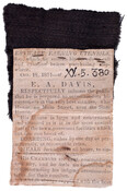 Piece of black satin and a newspaper clipping of article referring to Napoleon's deathledger having been on the funeral car of Napoleon at St. Helena.