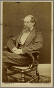 Portrait of author Charles Dickens, wearing a suit and sitting in a chair with his hands folded in his lap. Verso transcription: Dickens at time of his visit to Baltimore. Visited Z. Collins Lee 520 Park Avenue / [?] of Eliz. Collins Lee / Dickens.