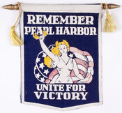 Hanging banner of wool, silk, and wood that reads "Remember Pearl Harbor Unite For Victory", ca. 1942-1945. "Remember Pearl Harbor" became a popular slogan and subject of numerous songs following the Japanese attack on the U.S. Naval base at Pearl Harbor, Hawaii on December 7, 1941.