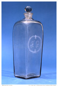 An Amelung glass gin bottle and stopper, with "F. G." engraved, made at John Frederick Amelung's New Bremen Glassworks Factory in Frederick, Maryland (working c. 1785-1795).