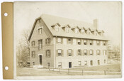 A view of a four-story office building owned by the Roland Park Company. The company was incorporated in 1891. Verso transcription: Office building #2 / The Roland Park Co.