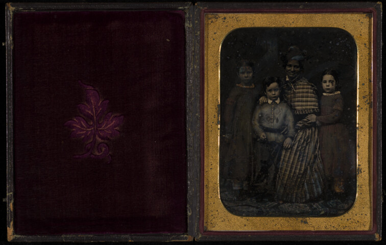 Portrait of the Lucas family children with African American woman — undated