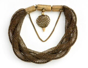 A bracelet of braided woven tubes of hair, pendant, and gold clasp from the Bonaparte collection.
