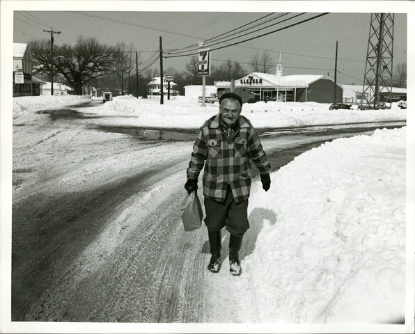 Man walking through snow from 7-Eleven — circa 1988